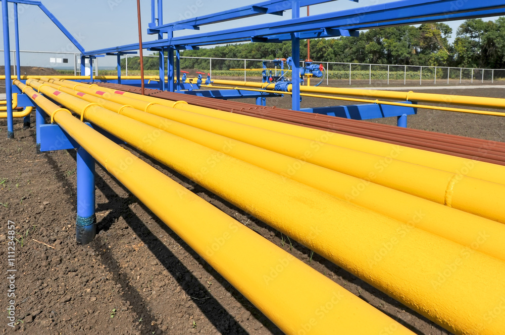 Yellow gas pipes in natural gas treatment plant in bright sunny summer day Yellow gas pipes in natural gas treatment plant in bright sunny summer day