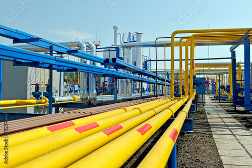 Yellow gas pipes in natural gas treatment plant in bright sunny summer day photo