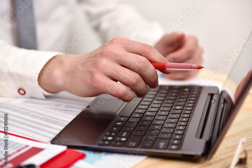 Businessman hand pointing to screen laptop