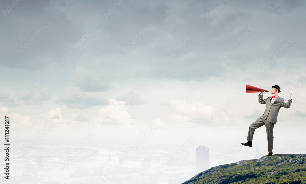 Businessman in hat with trumpet