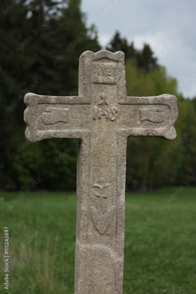Fraciscan Stone cross in countryside 