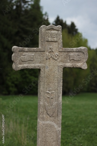 Fraciscan Stone cross in countryside 