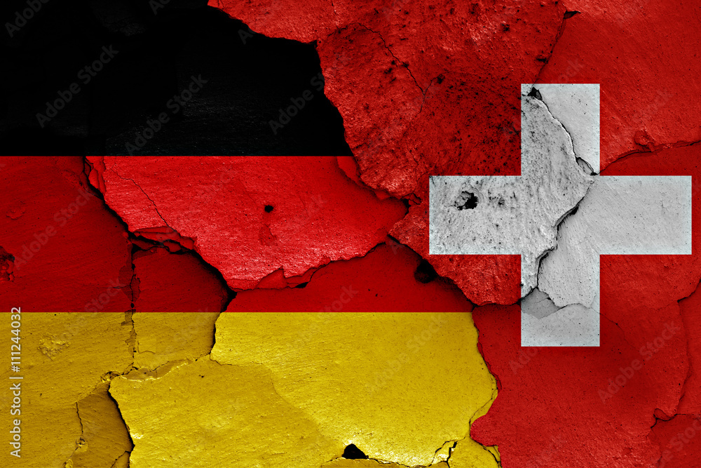 flags of Germany and Switzerland painted on cracked wall