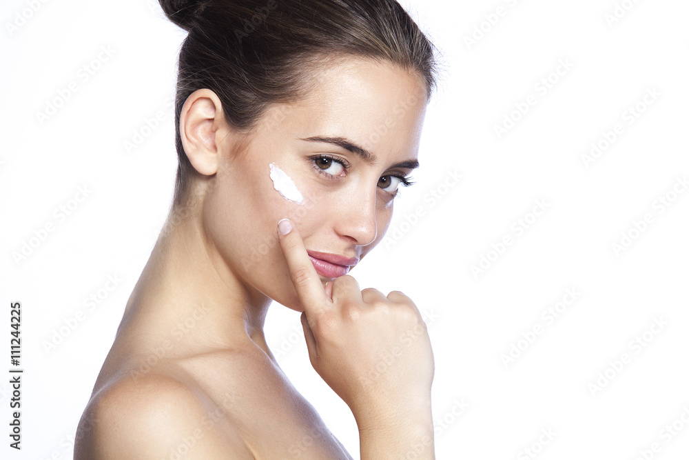 Side view of beautiful woman with cosmetic cream on a clean fresh face. Skin care concept Side view of beautiful woman with cosmetic cream on a clean fresh face. Skin care concept