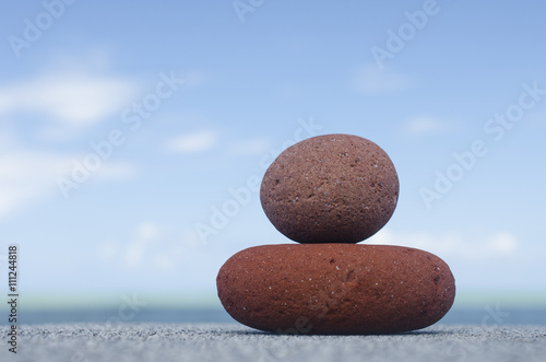 balancing stones on a background of blue sky