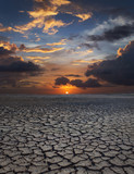 global warming. dramatic sky over cracked earth