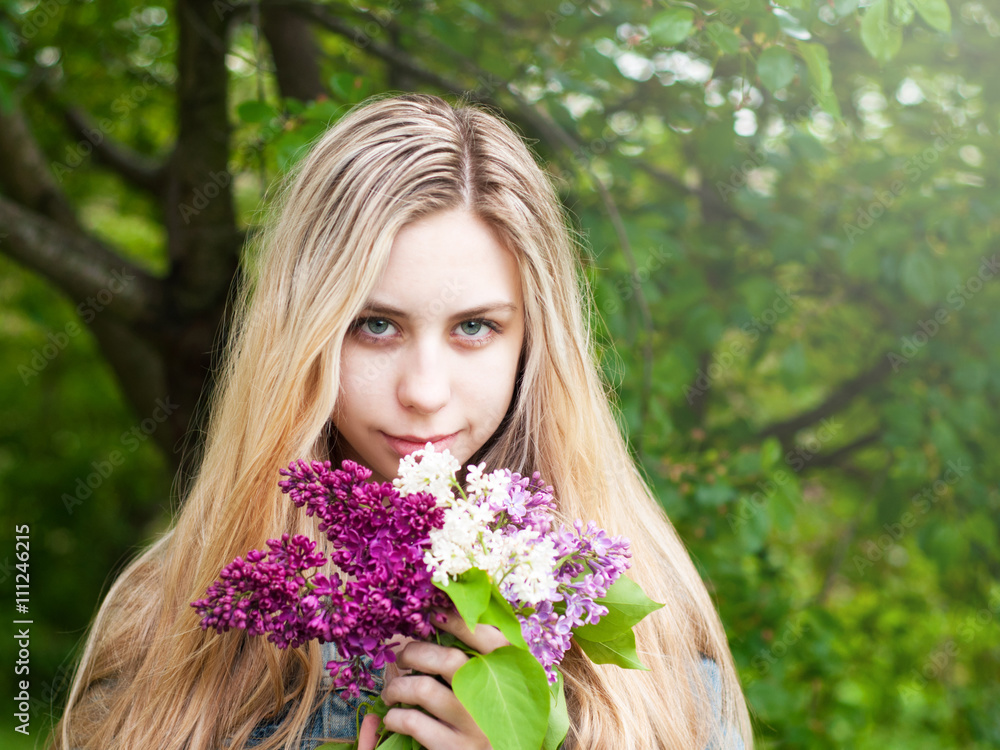 Girl with a bouquet of lilacs