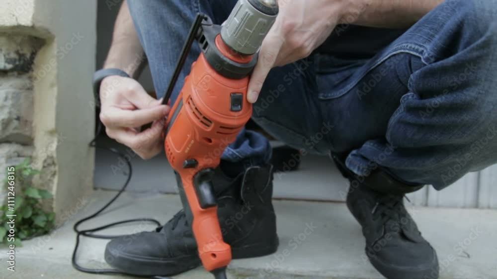 Worker Man is Assembling the Drill Bit. Worker Man is Assembling the Drill Bit.