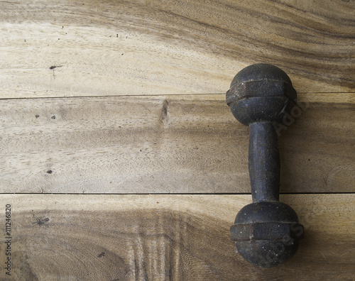 metal dumbbell on a old wooden background
