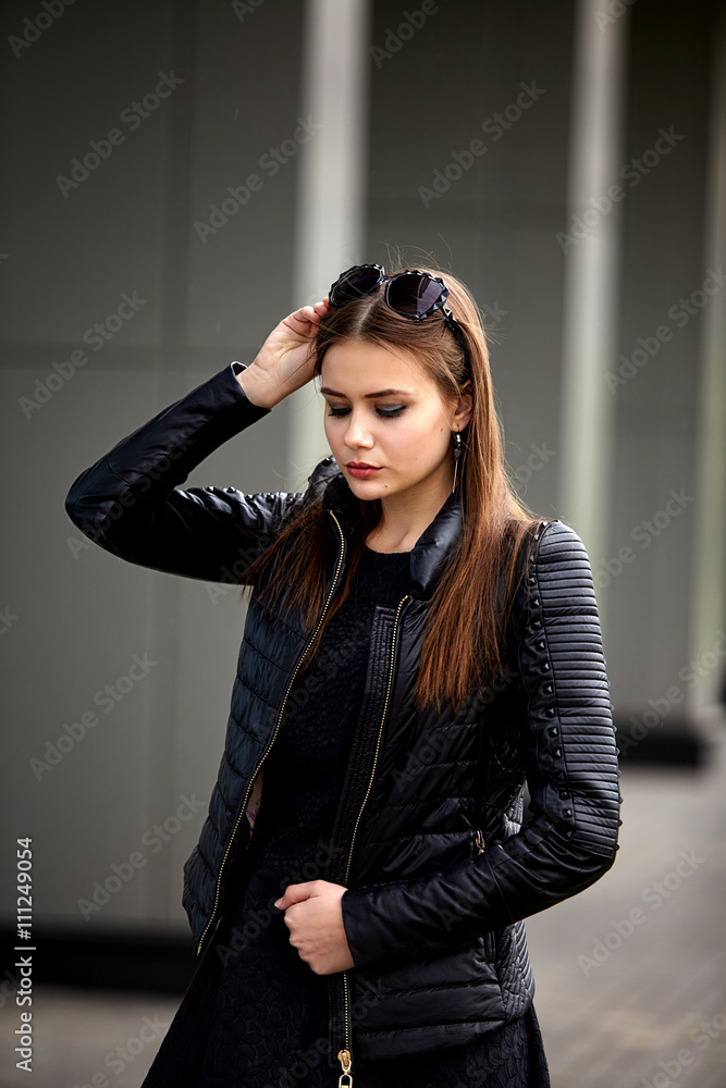 Fashion concept. Portrait close up of young beautiful fashionable brunette woman with sunglasses. City lifestyle. Female fashion. Closeup portrait