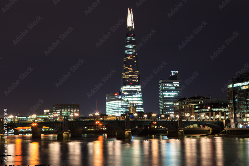 The Shard skyscraper and Thames river at sunset in London, UK