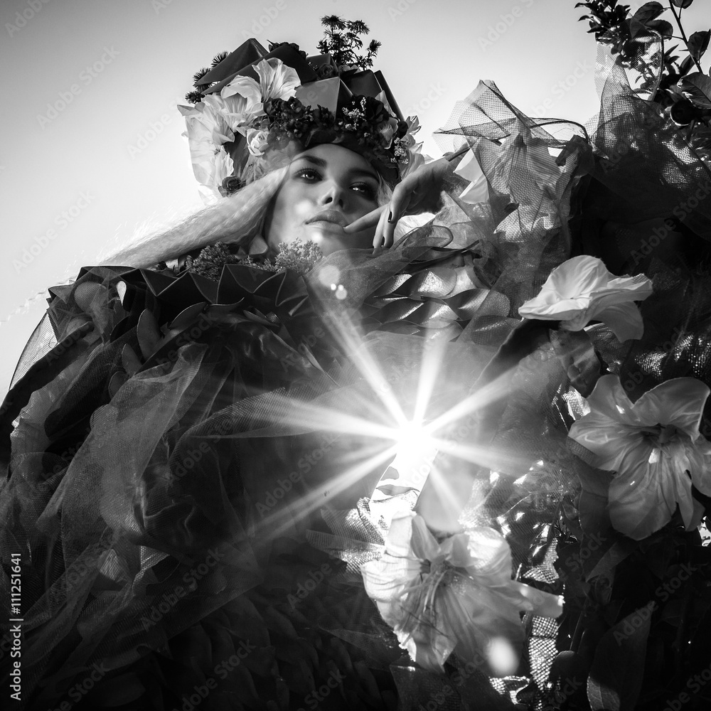 Fototapeta premium Dramatized image of sensual girl symbolizing nature. Black-white art fashion outdoor photo.