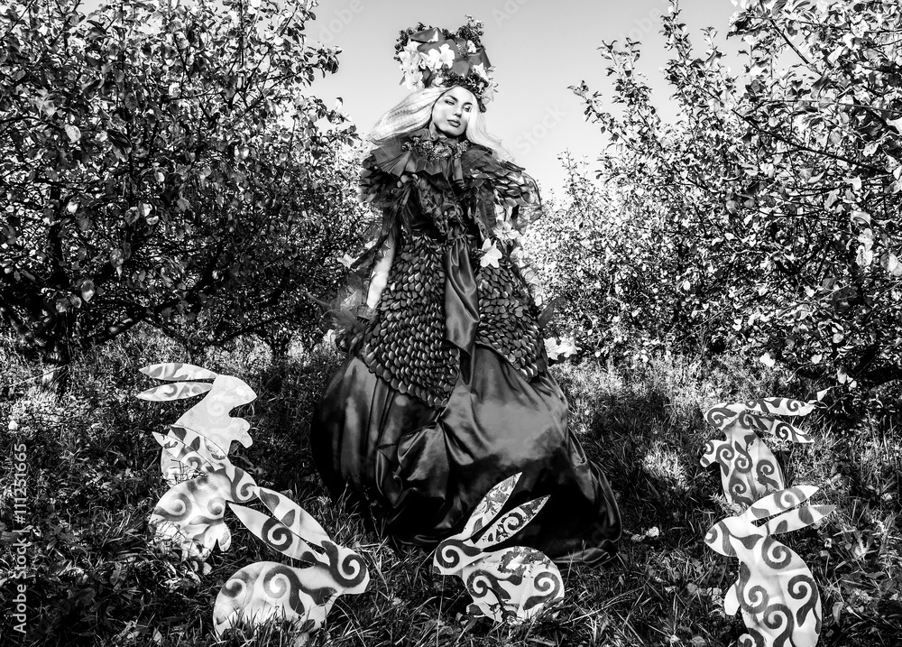 Fototapeta premium Dramatized image of sensual girl symbolizing nature. Black-white art fashion outdoor photo.