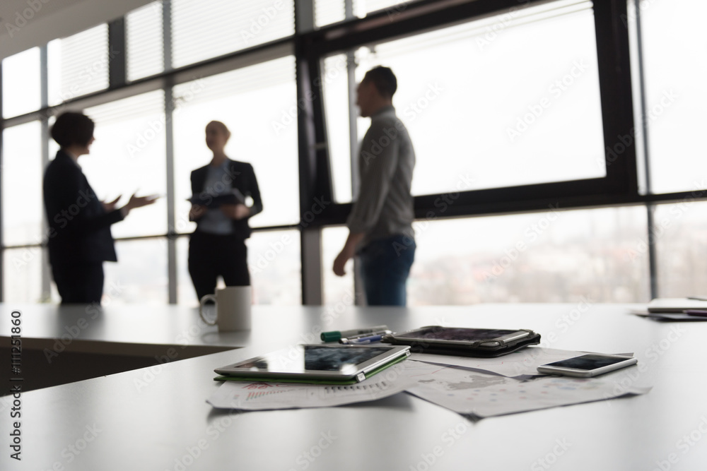 © .shock - close up of tablet, business people on meeting in background © .shock - close up of tablet, business people on meeting in background