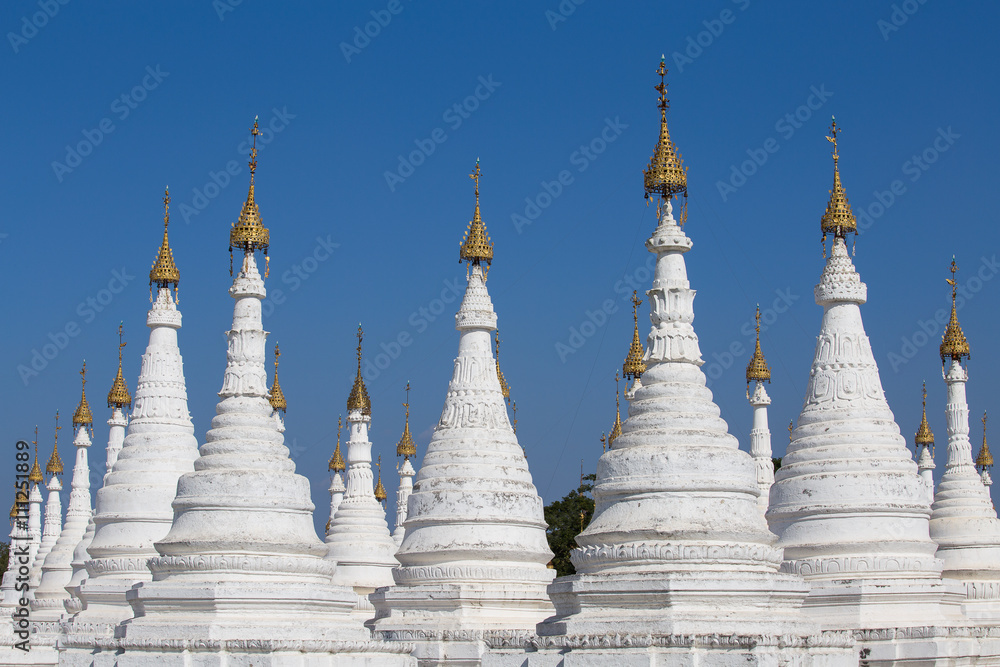 Fototapeta premium White Pagoda at blue sky background in Mandalay, Myanmar, Burma