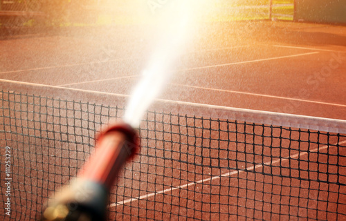 Maintenance sprinkler tennis court photo