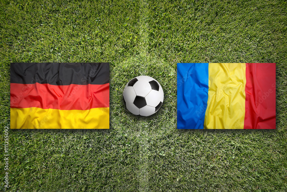 Fototapeta premium Germany vs. Romania flags on soccer field