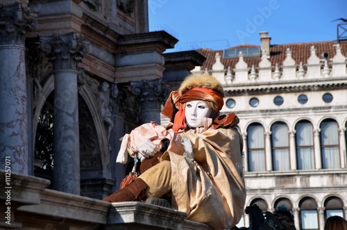 Someone sitting on the wall during the Venice carnival