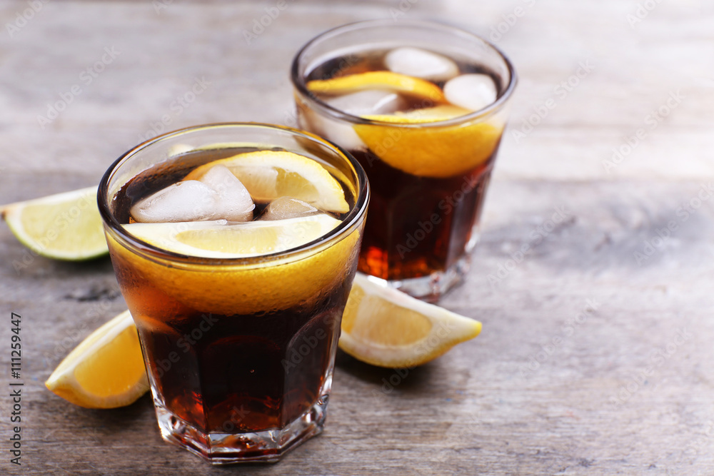 Glasses of soda water with sliced lemon on wooden table Glasses of soda water with sliced lemon on wooden table