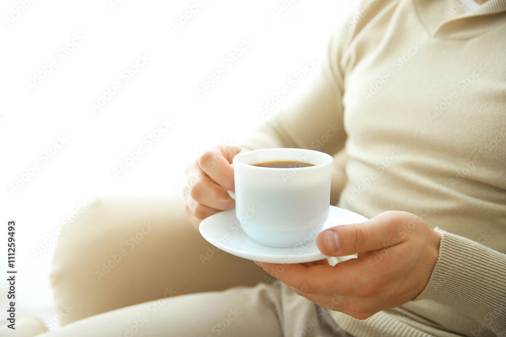 Man holding cup of coffee in hands, close up Man holding cup of coffee in hands, close up
