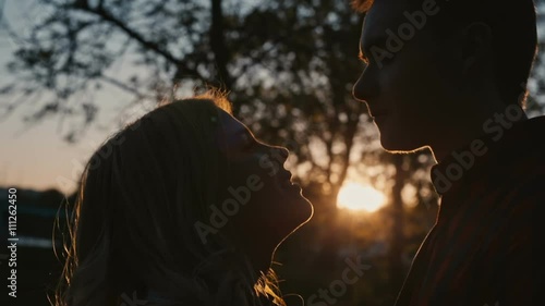 Young romantic couple first kiss photo