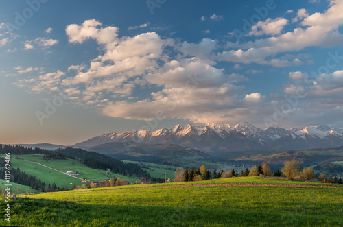 Beautiful spring panorama of Tatra mountains and green hills © tomeyk