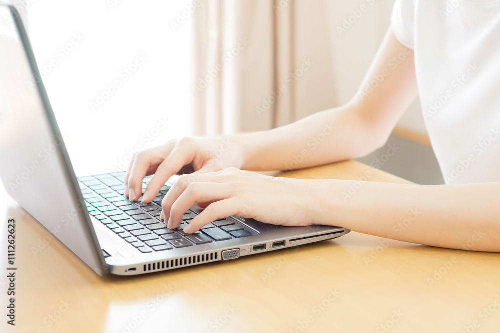 Fototapeta premium Rear view of business woman hands busy using laptop at office de