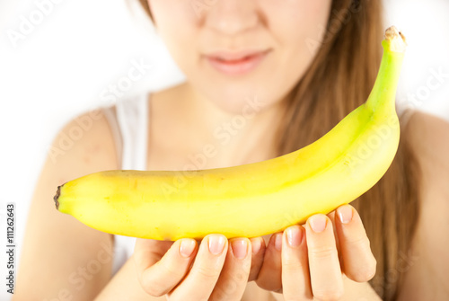 A young beautiful woman with a banana