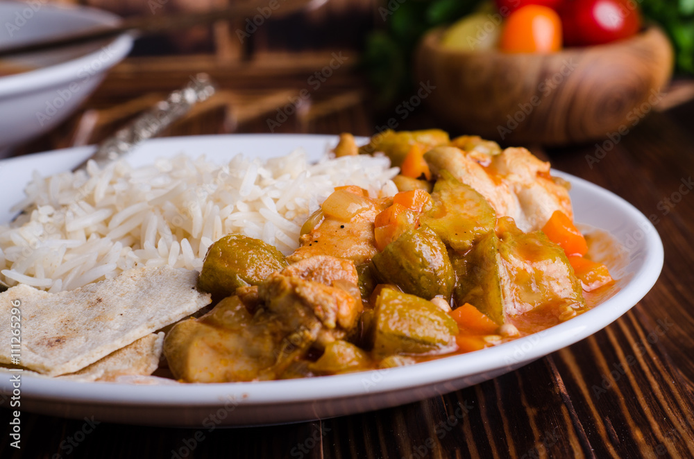 Ragout with chicken and okra or bamia or lady finger in white bowl on wooden background. Selective focus Ragout with chicken and okra or bamia or lady finger in white bowl on wooden background. Selective focus