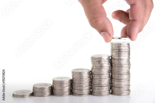 man hand putting a coin on growth coin stack