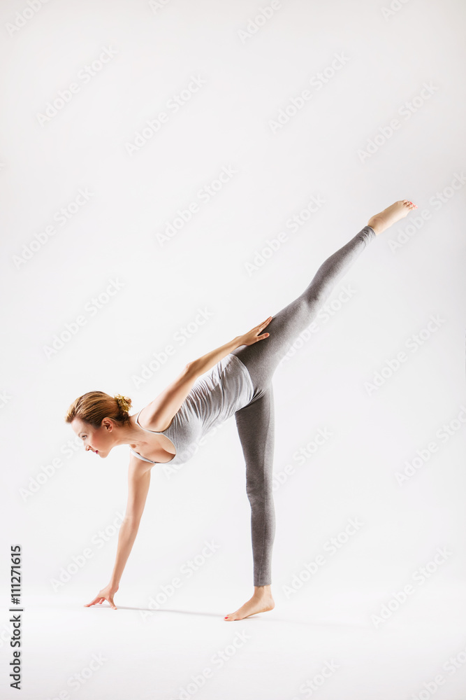 Pretty sporty blonde in doing yoga on white background Pretty sporty blonde in doing yoga on white background