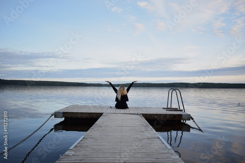 Young blonde woman with beautiful swedish landscape in the background