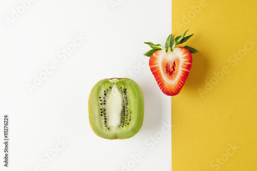 Kiwi and strawberry on yellow white background fruits summer