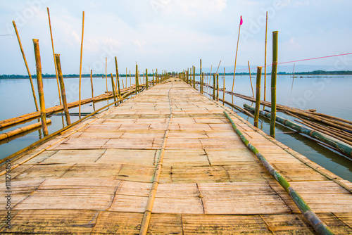 Bamboo bridge on the lake photo