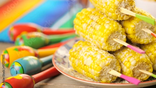 Fiesta party buffet table with spicy mexican corn on the cob and other traditional Mexican food