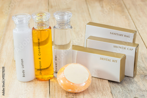 Tubes of bathroom amenity contains on wooden background