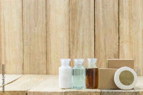Tubes of bathroom amenity contains on wooden background