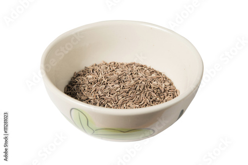 Isolated bowl of dried cumin seed on the white background
