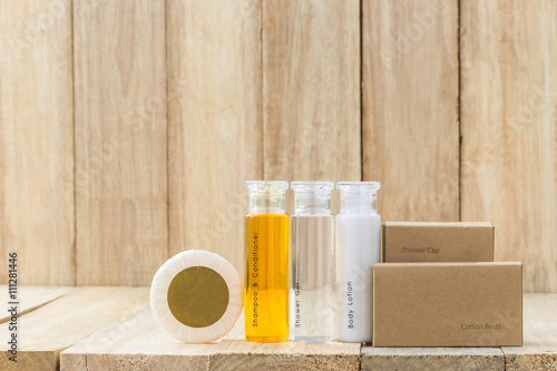 Tubes of bathroom amenity contains on wooden background