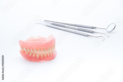 Denture and dental tools dental mirror on white background