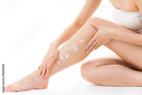 脚にクリームを塗る女性