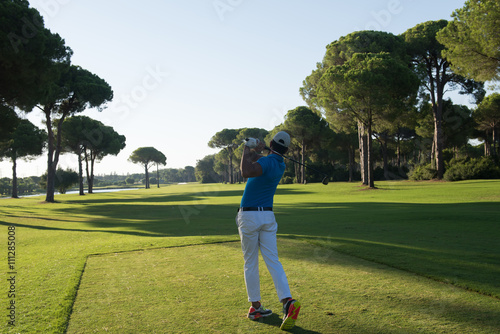 golf player hitting shot