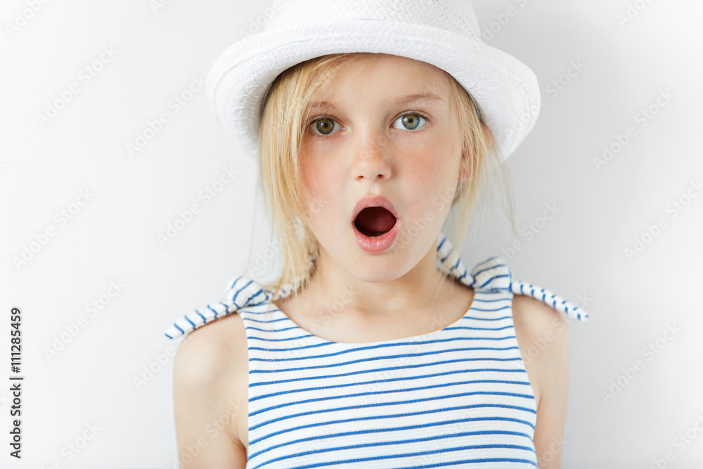 close-up-portrait-of-amazed-adorable-little-girl-in-white-hat-and