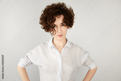 Photos Close up portrait of skeptical young woman looking suspicious, with disgusted expression, mixed with disapproval, isolated against white background