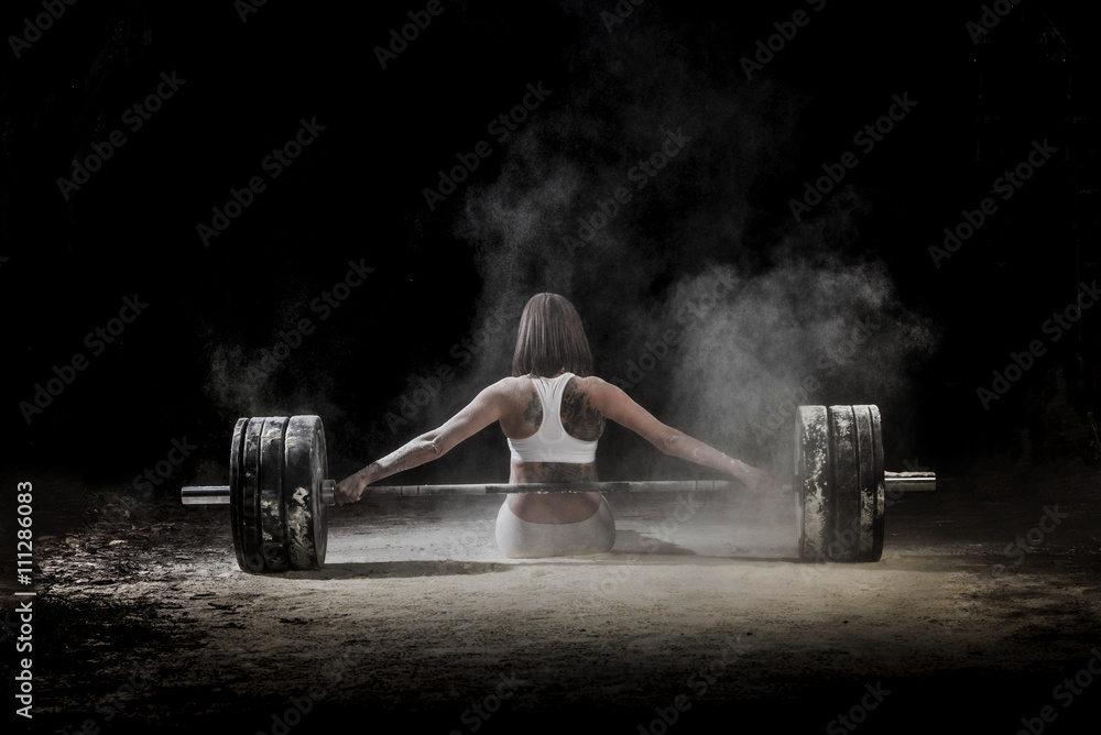 © ADDICTIVE STOCK - Woman working out with weights in the gym