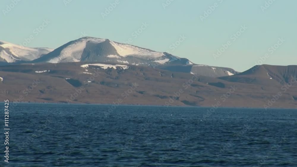 Snowy mountains and the sea in Arctic. Iceland. Fantastic wonderful amazing video grenland nature iceland. Lovely shooting the life of nature, seaside and mountains. Snowy mountains and the sea in Arctic. Iceland. Fantastic wonderful amazing video grenland nature iceland. Lovely shooting the life of nature, seaside and mountains.