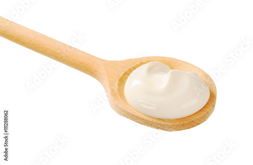 Sour cream on a wooden spoon