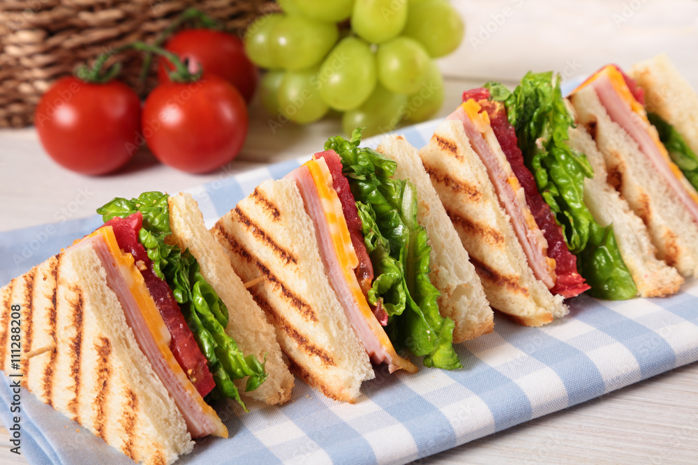 Summer picnic club sandwich ham and cheese in a row Summer picnic club sandwich ham and cheese in a row