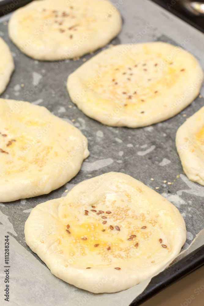Pastry with sesame seeds ready for baking in the oven Pastry with sesame seeds ready for baking in the oven