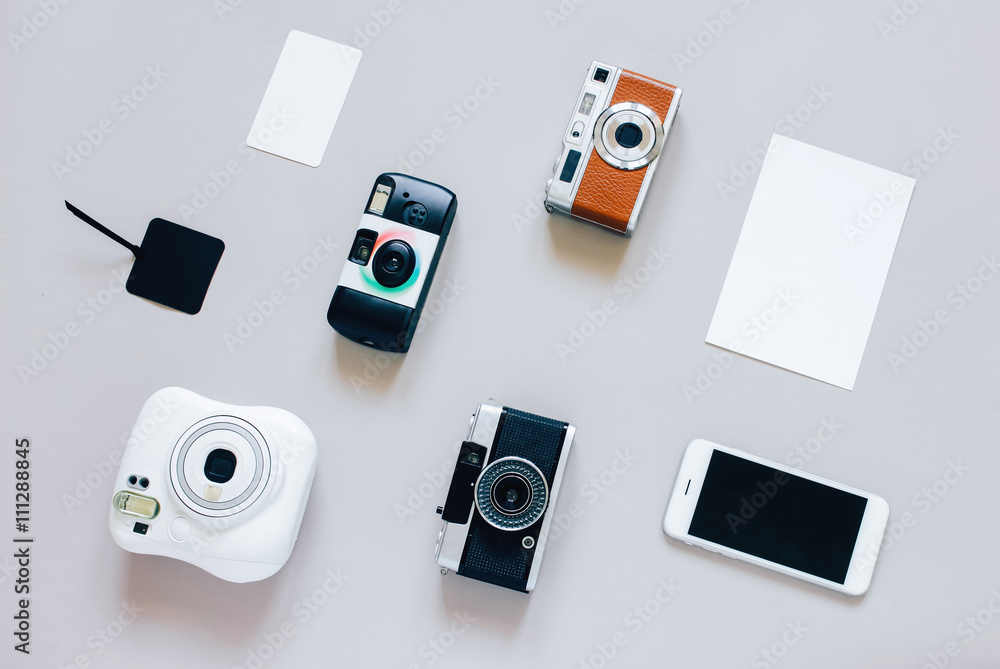 Flat lay of various of cameras style with smartphone and blank c